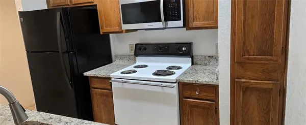 a kitchen with metallic refrigerator and a stove