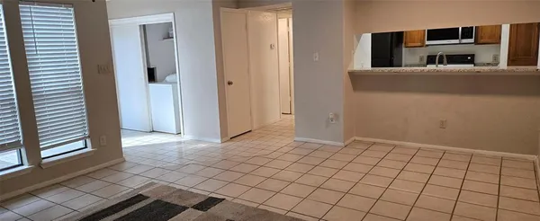 a view of a livingroom with an empty space and window