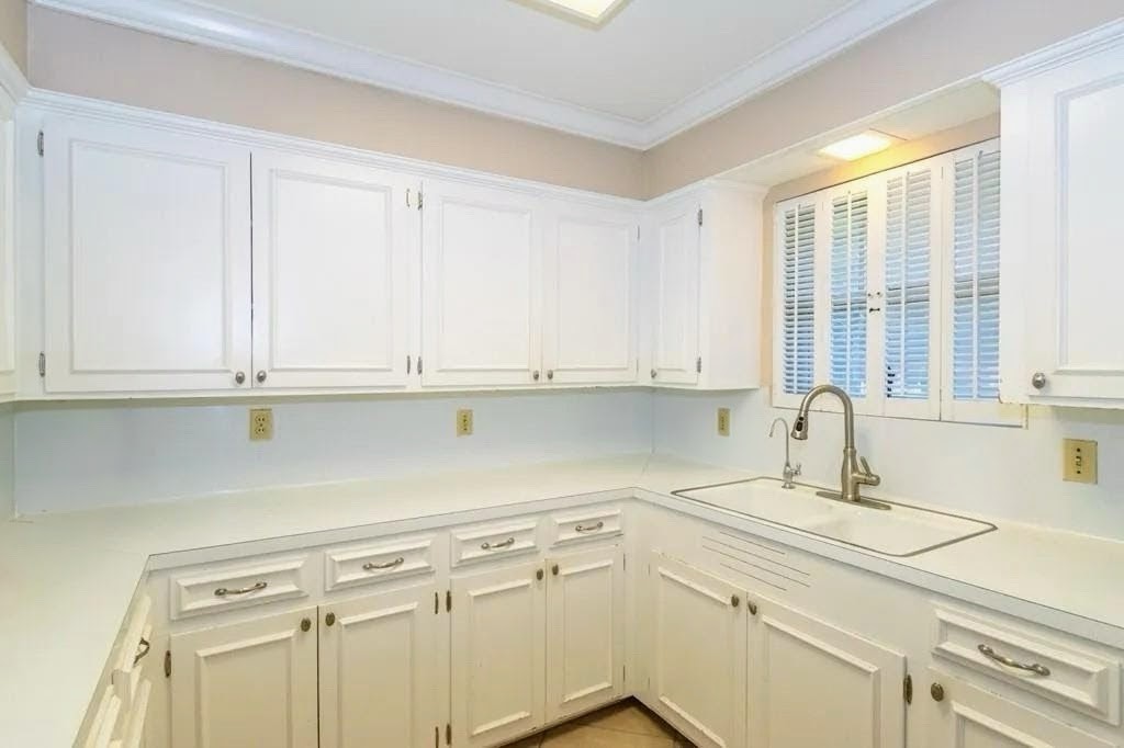 1118 Lincoln Street Alice, TX 78332 - Photo 9 of 32 a kitchen with granite countertop white cabinets and a sink