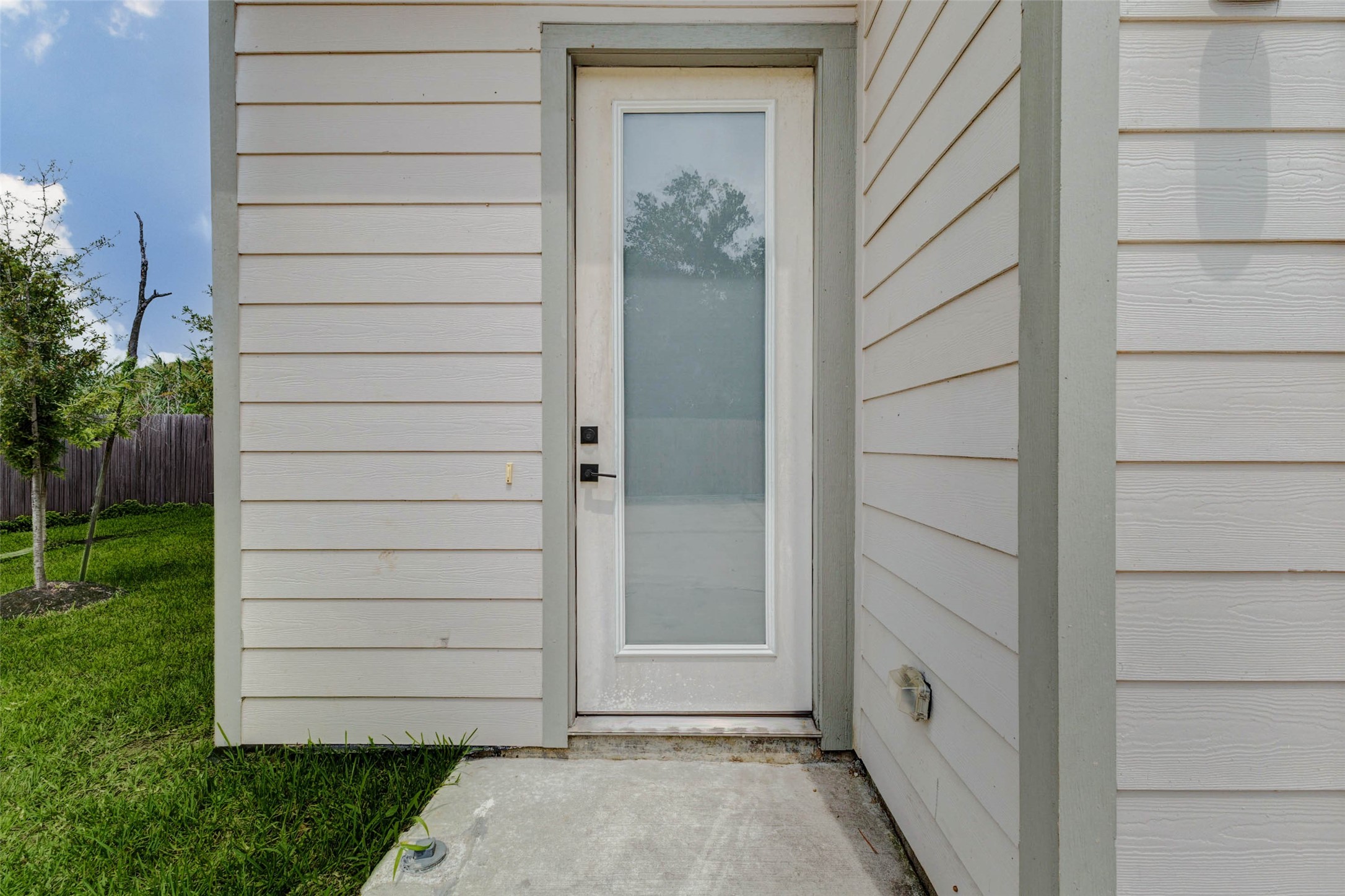 5705 Elysium Street Houston, TX 77091 - Photo 2 of 22 The side-entry perspective showcases the home’s contemporary siding, tall window detail, and clean exterior finish. This angle reinforces the newer construction feel and streamlined design of the property.