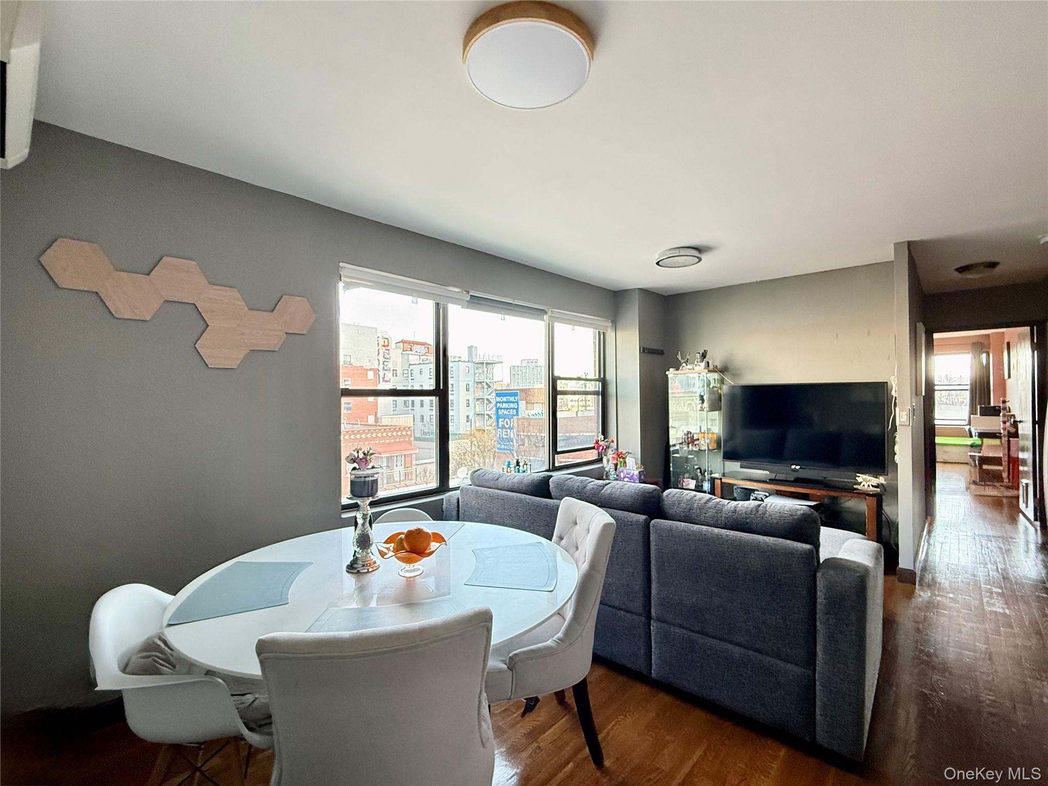 87-14 57th Road, Unit 5A Queens, NY 11373 - Photo 11 of 34 a living room with furniture and a flat screen tv