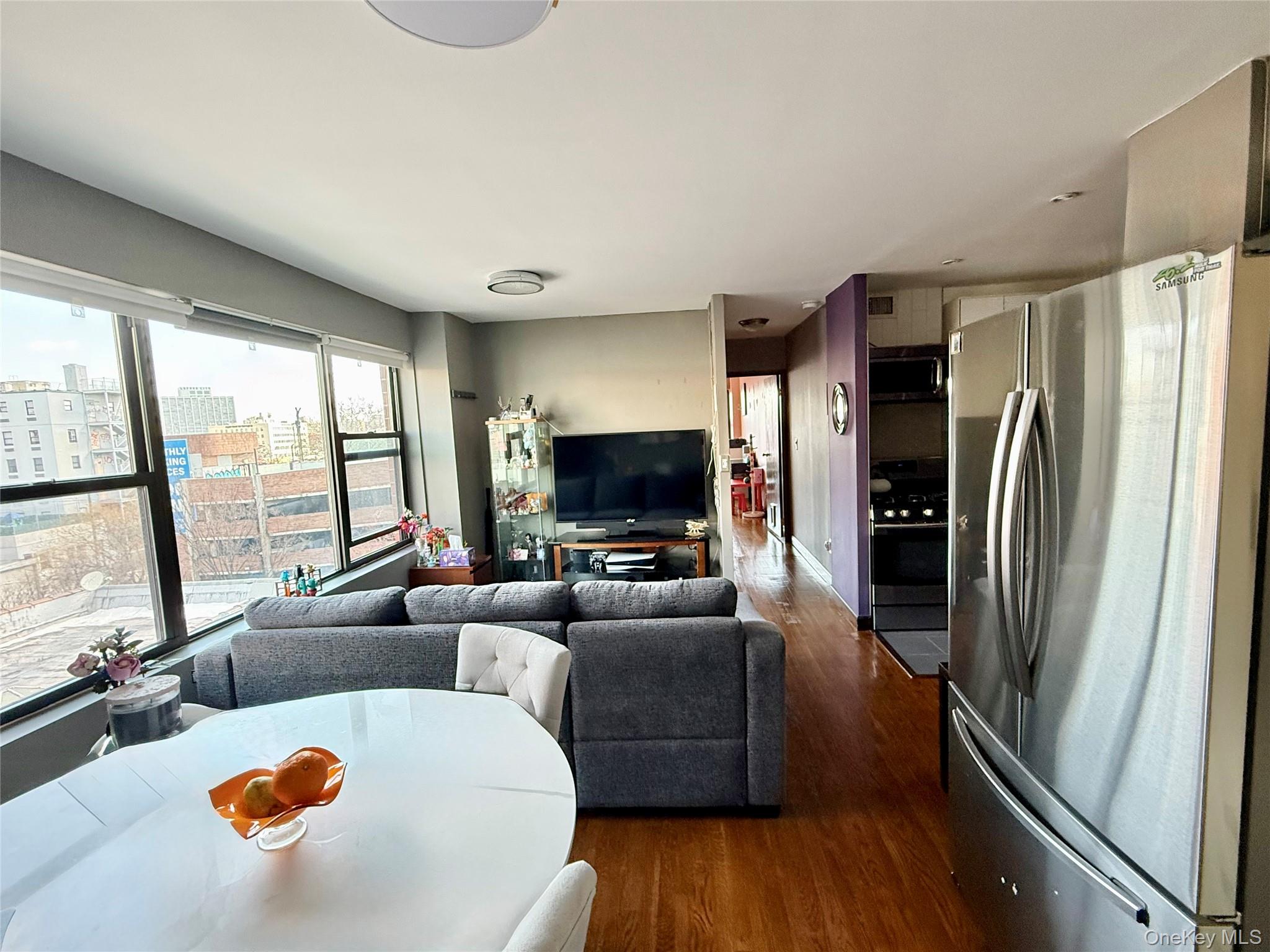 87-14 57th Road, Unit 5A Queens, NY 11373 - Photo 12 of 34 a living room with furniture and a flat screen tv