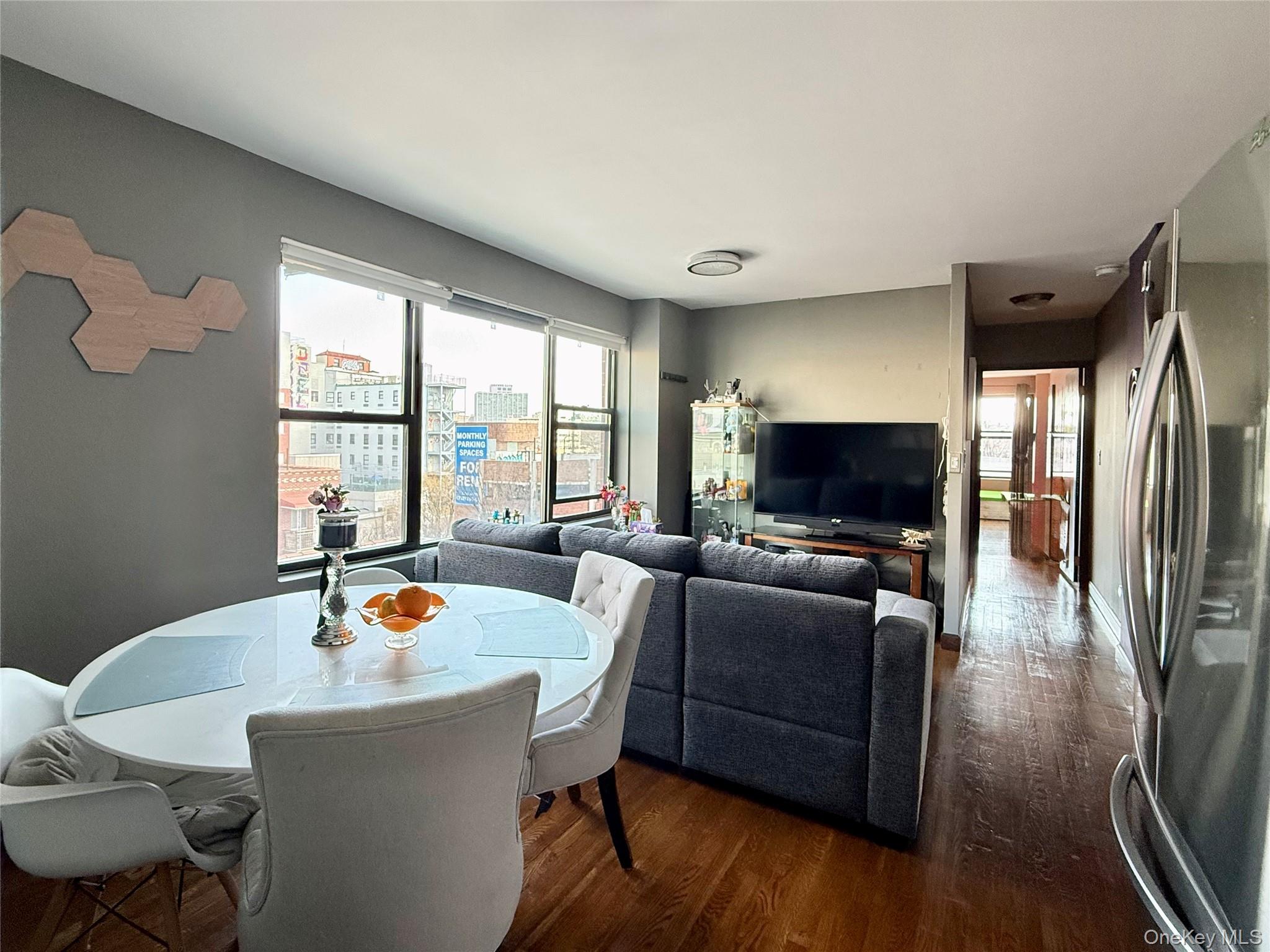 87-14 57th Road, Unit 5A Queens, NY 11373 - Photo 13 of 34 a living room with furniture and a flat screen tv