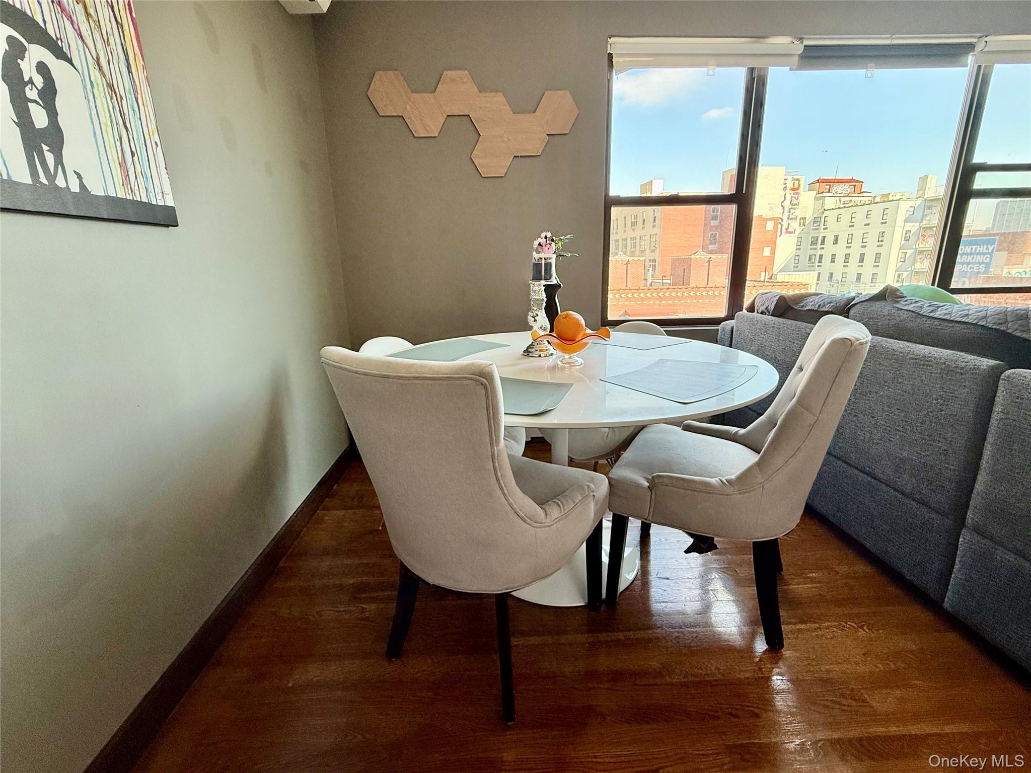 87-14 57th Road, Unit 5A Queens, NY 11373 - Photo 14 of 34 a view of a dining room with furniture a potted plant and wooden floor