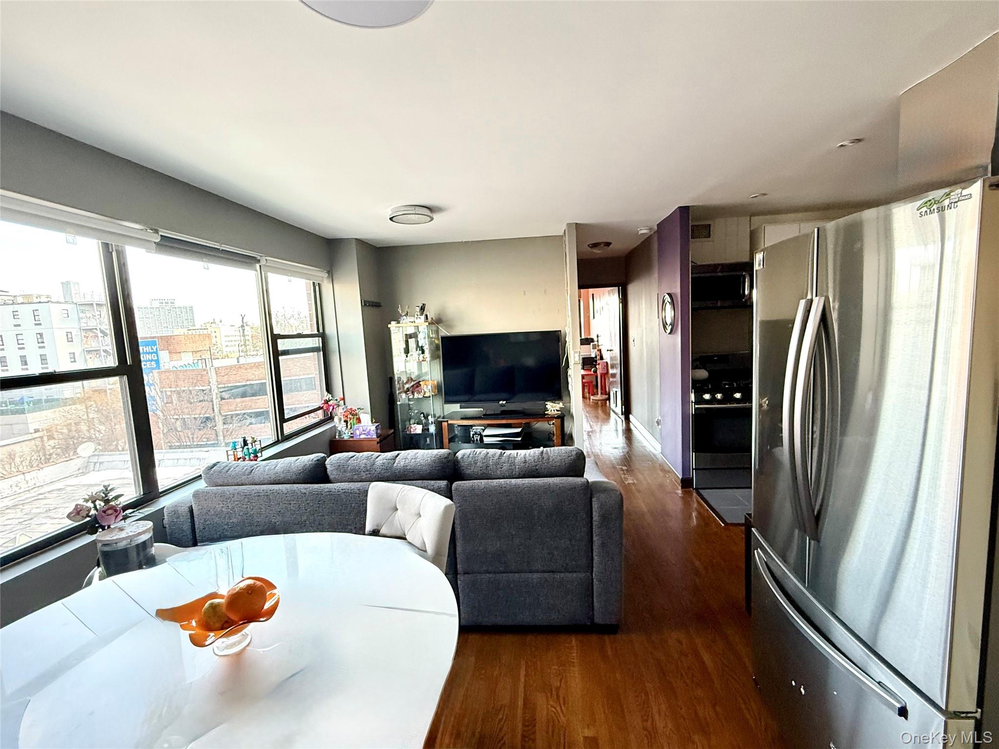 87-14 57th Road, Unit 5A Queens, NY 11373 - Photo 17 of 34 a living room with furniture and a flat screen tv