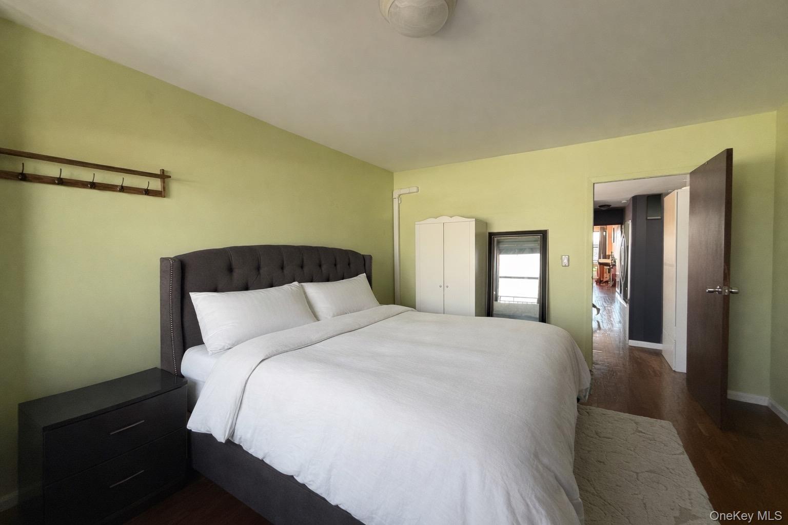 87-14 57th Road, Unit 5A Queens, NY 11373 - Photo 18 of 34 a bedroom with a bed and a mirror