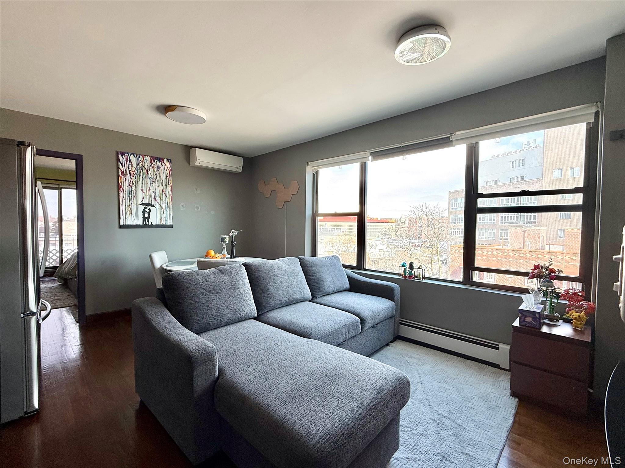 87-14 57th Road, Unit 5A Queens, NY 11373 - Photo 2 of 34 a living room with furniture and a large window