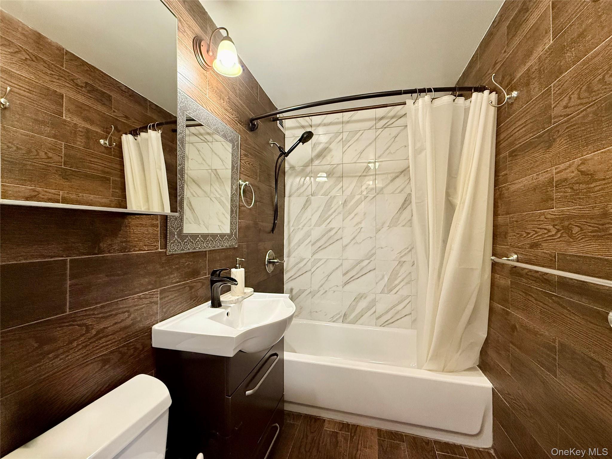 87-14 57th Road, Unit 5A Queens, NY 11373 - Photo 20 of 34 a bathroom with a sink toilet and shower