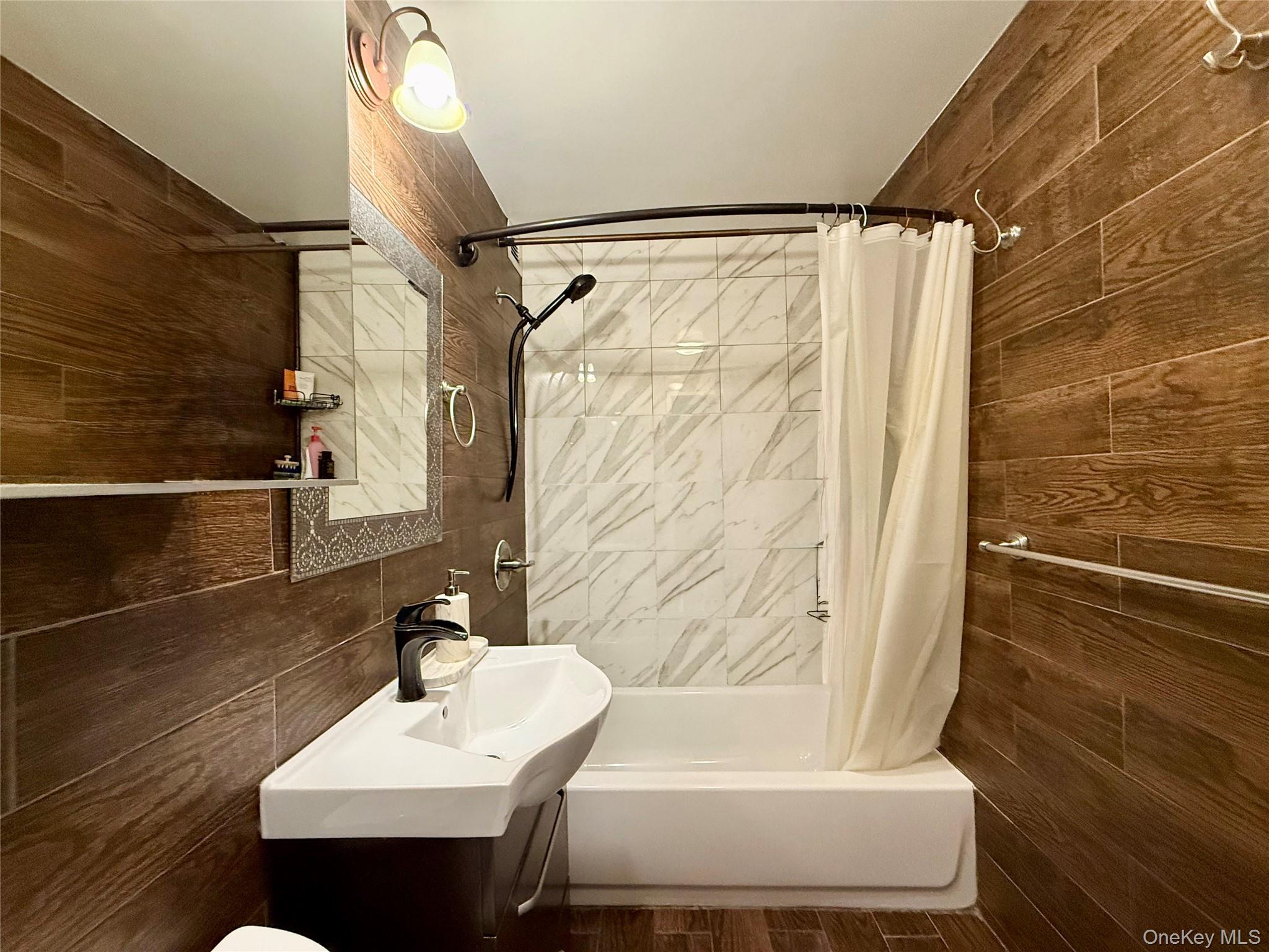 87-14 57th Road, Unit 5A Queens, NY 11373 - Photo 21 of 34 a bathroom with a sink and a mirror