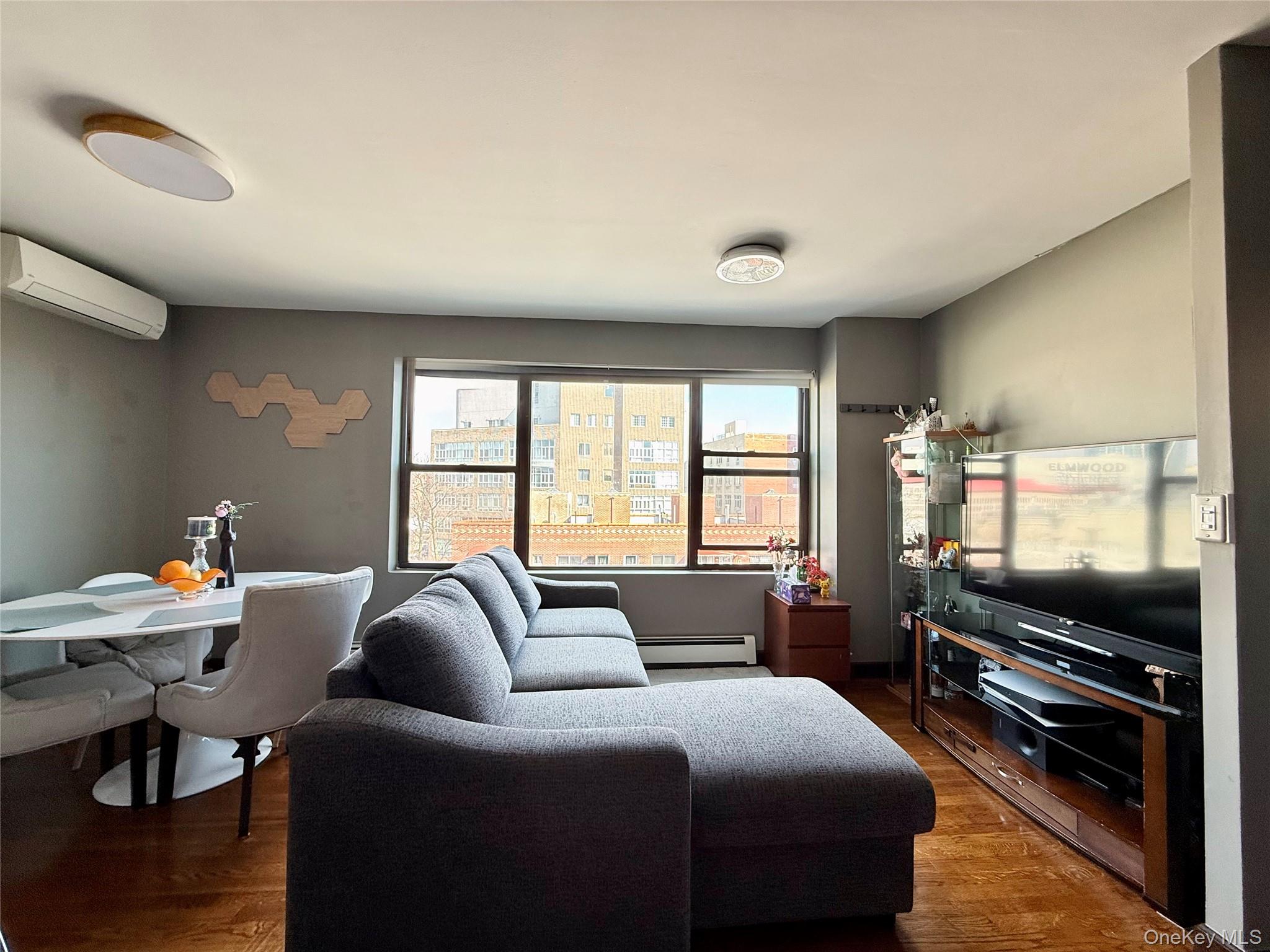 87-14 57th Road, Unit 5A Queens, NY 11373 - Photo 3 of 34 a bedroom with furniture and a flat screen tv