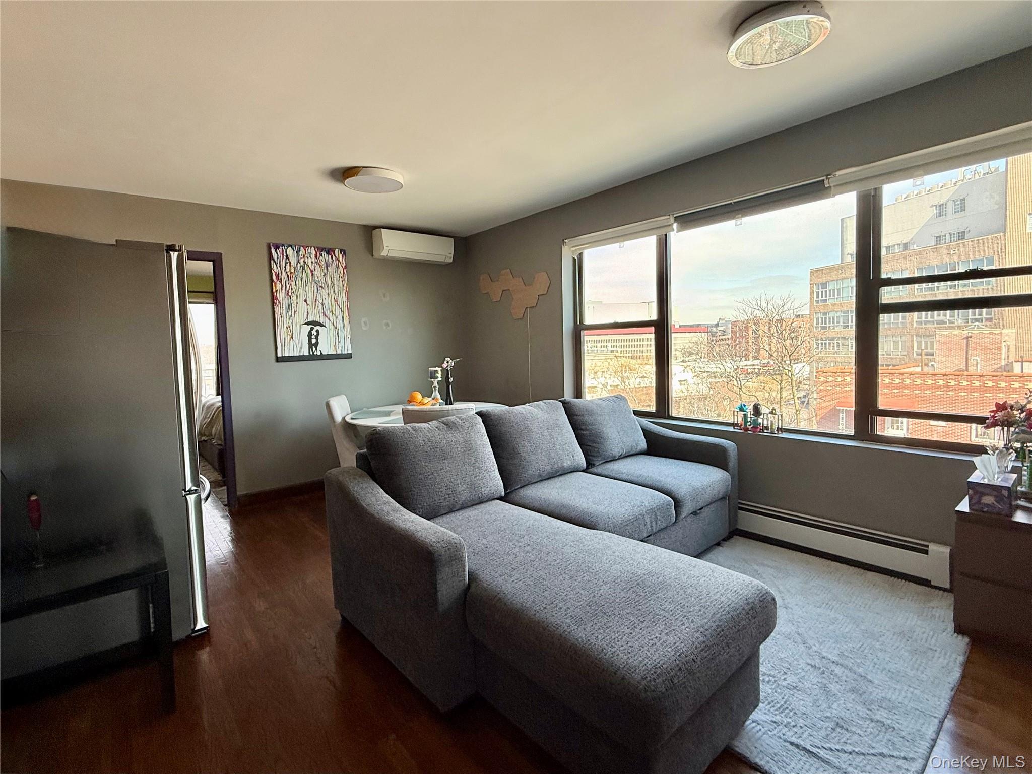 87-14 57th Road, Unit 5A Queens, NY 11373 - Photo 4 of 34 a living room with furniture and a large window