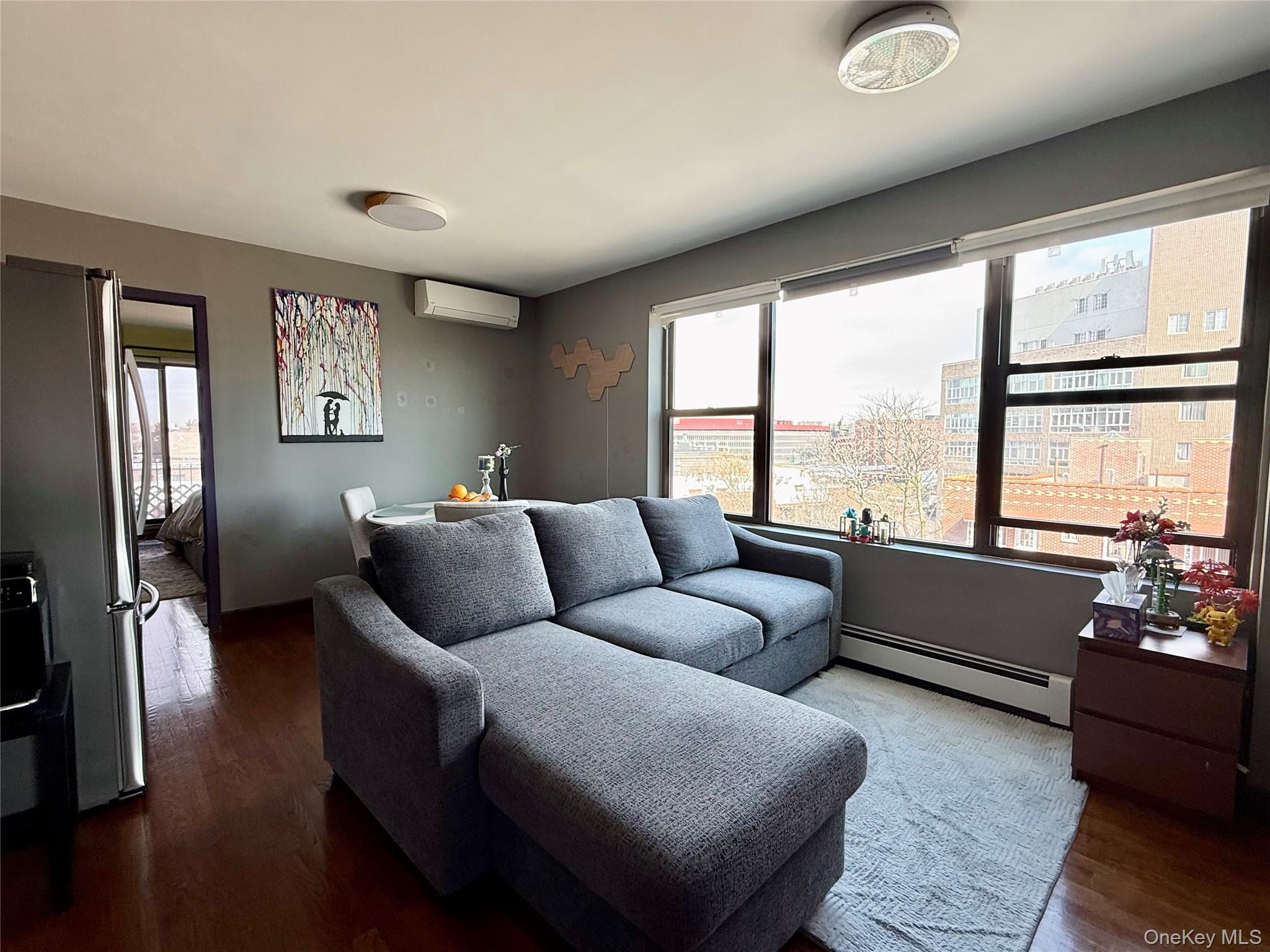 87-14 57th Road, Unit 5A Queens, NY 11373 - Photo 7 of 34 a living room with furniture and a large window