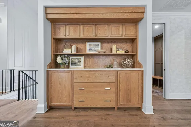 a living room with furniture a large window and kitchen appliances