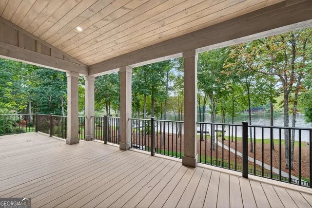 a bathroom with a granite countertop sink a toilet and a mirror
