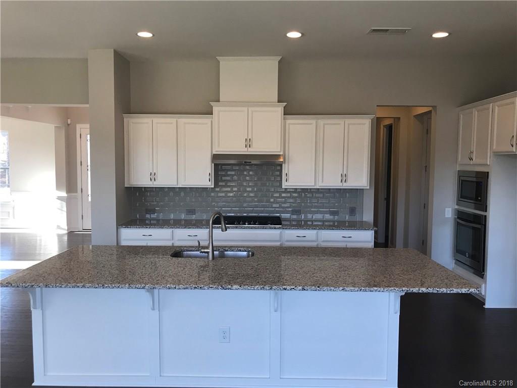 1342 Afton Way, Unit 121 Fort Mill, SC 29708 - Photo 3 of 12 a kitchen with stainless steel appliances granite countertop a sink stove and refrigerator