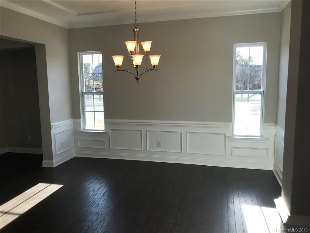1342 Afton Way, Unit 121 Fort Mill, SC 29708 - Photo 5 of 12 a view of an empty room with wooden floor and a window
