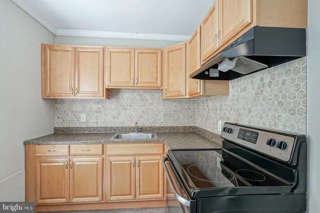 a kitchen with stainless steel appliances granite countertop a stove and a sink
