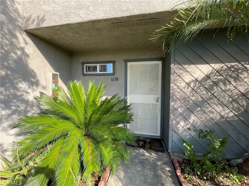 1658 Puente Avenue, Unit 10 Baldwin Park, CA 91706 - Photo 1 of 1 a plant is in front of a house