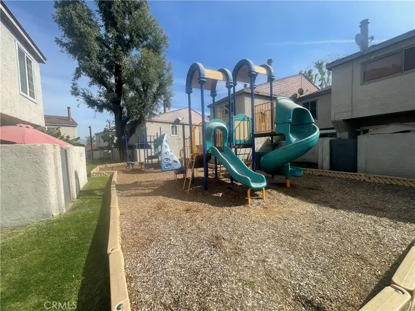 a backyard of a house with a yard and outdoor seating
