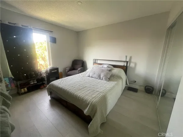 a bedroom with a bed and a mirror