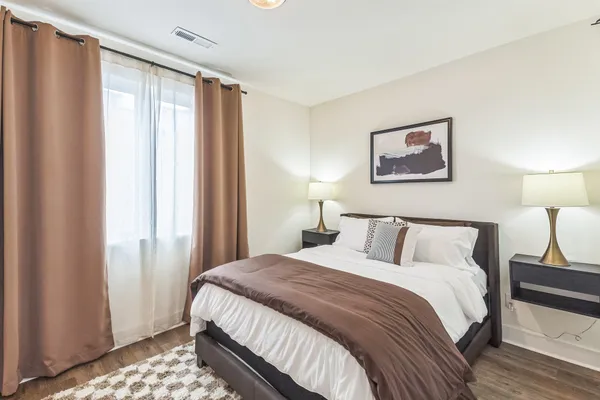 a bedroom with a bed and a window