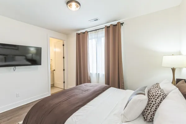 a bedroom with a bed and a flat screen tv