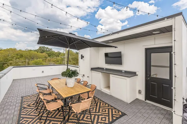a patio with a table and chairs