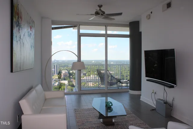 a living room with couches and a flat screen tv
