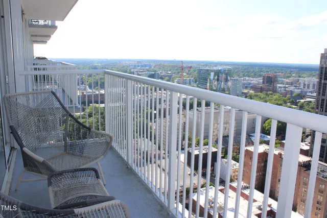 a view of a balcony with wooden floor