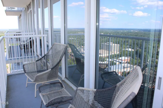 a view of a balcony with furniture