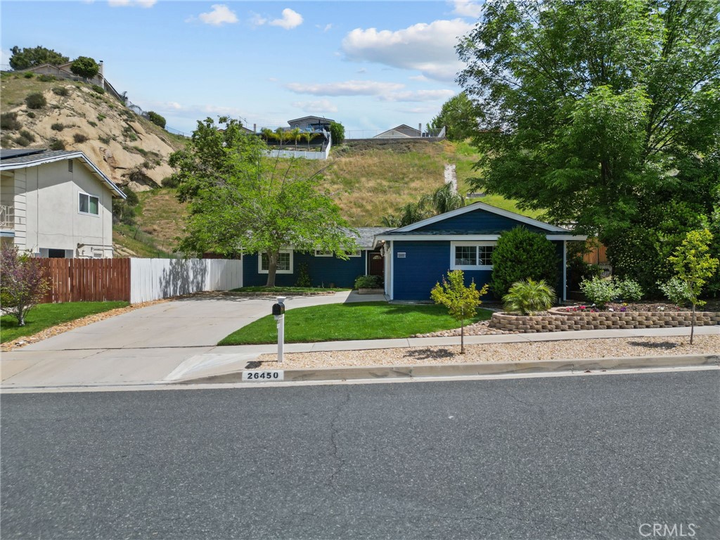 26450 Ridge Vale Drive Newhall, CA 91321 - Photo 1 of 40 a house with a garden and wooden fence