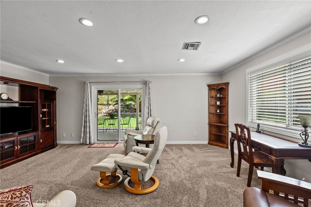 26450 Ridge Vale Drive Newhall, CA 91321 - Photo 16 of 40 a living room with furniture a flat screen tv and a window