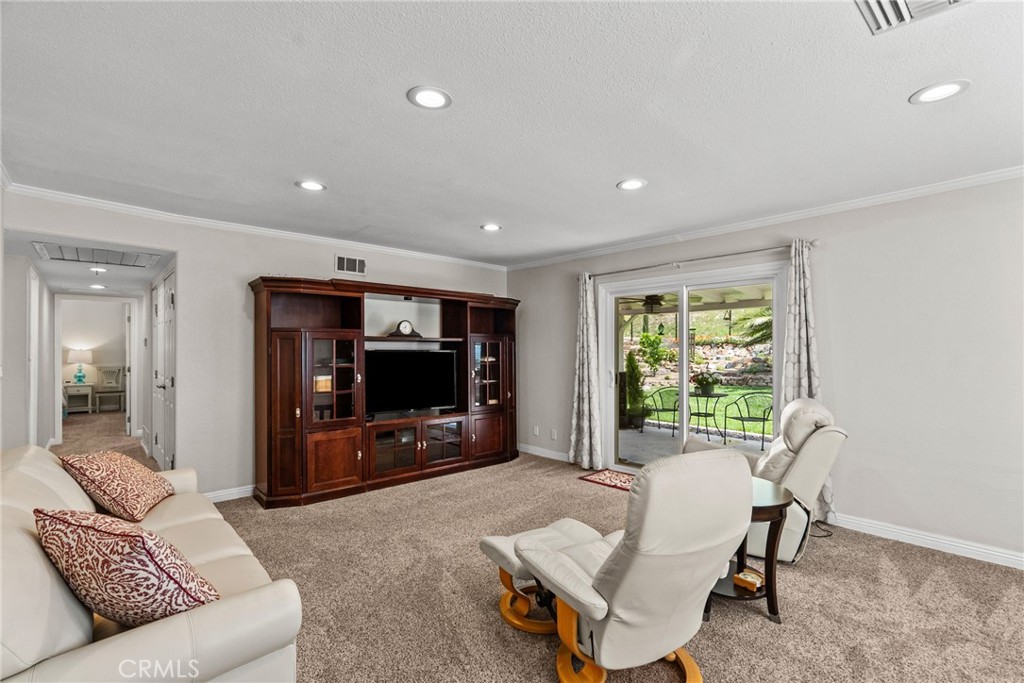 26450 Ridge Vale Drive Newhall, CA 91321 - Photo 17 of 40 a living room with furniture and a flat screen tv