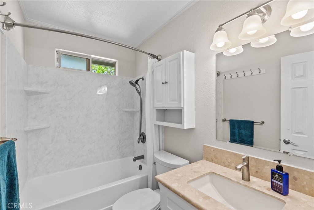 26450 Ridge Vale Drive Newhall, CA 91321 - Photo 21 of 40 a bathroom with a granite countertop sink a toilet and shower