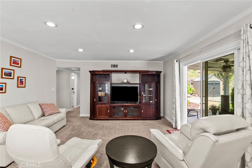 26450 Ridge Vale Drive Newhall, CA 91321 - Photo 28 of 40 a living room with furniture and a flat screen tv