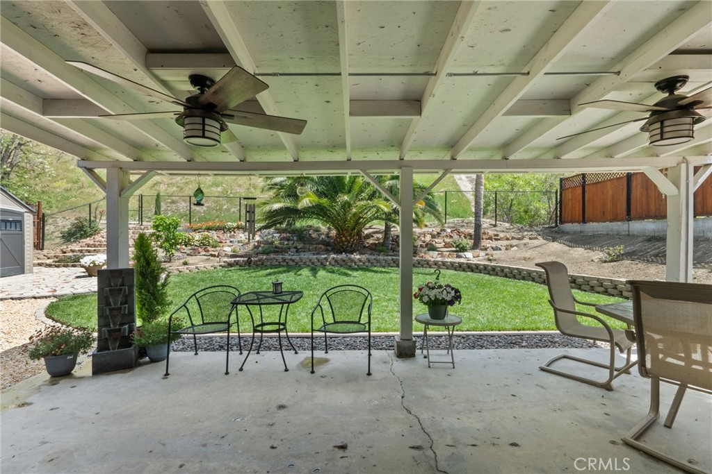 26450 Ridge Vale Drive Newhall, CA 91321 - Photo 31 of 40 a view of a porch with furniture and a table
