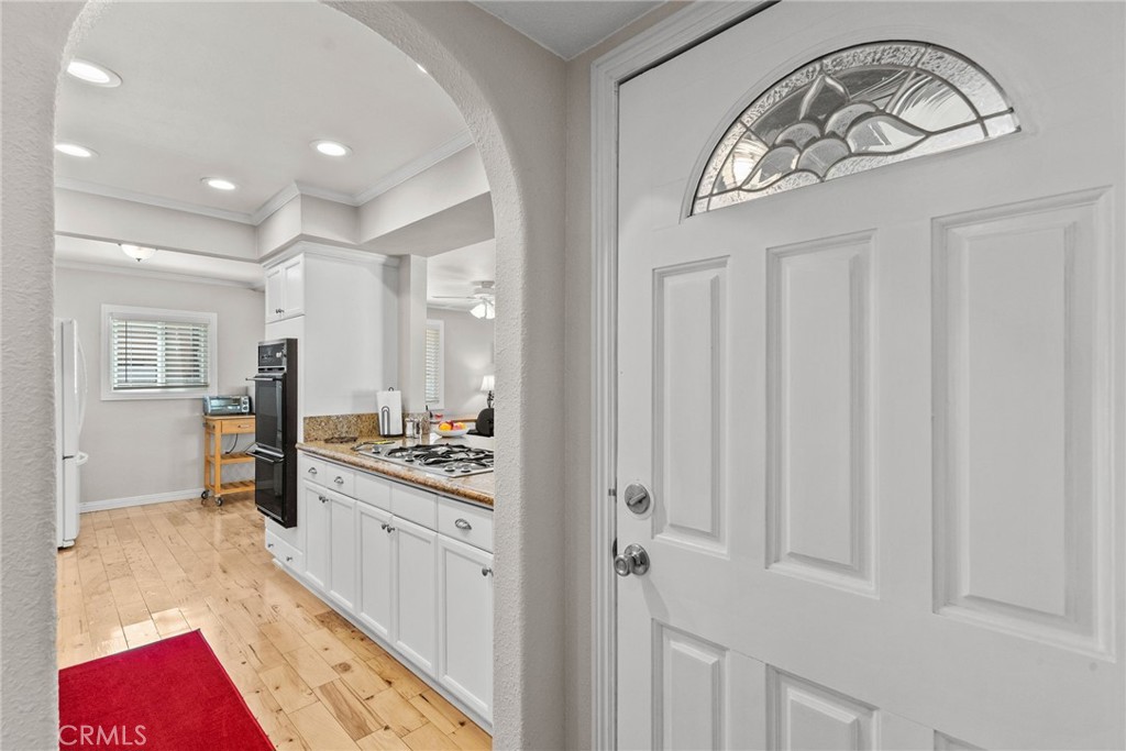 26450 Ridge Vale Drive Newhall, CA 91321 - Photo 5 of 40 a kitchen with stainless steel appliances granite countertop a stove a sink and a refrigerator with wooden floor