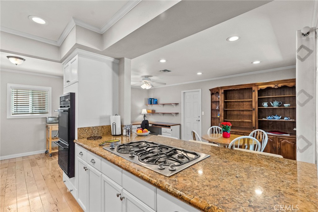 26450 Ridge Vale Drive Newhall, CA 91321 - Photo 8 of 40 a kitchen with stainless steel appliances granite countertop a stove and a refrigerator