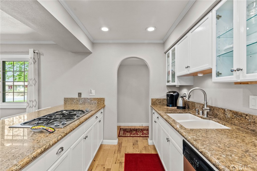 26450 Ridge Vale Drive Newhall, CA 91321 - Photo 9 of 40 a kitchen with granite countertop a sink stove and cabinets