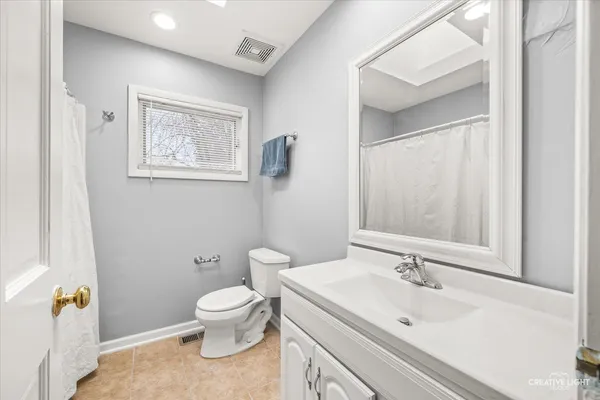 a white toilet sitting next to a bathroom sink