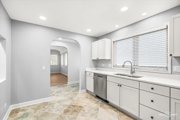 a kitchen with a sink and cabinets