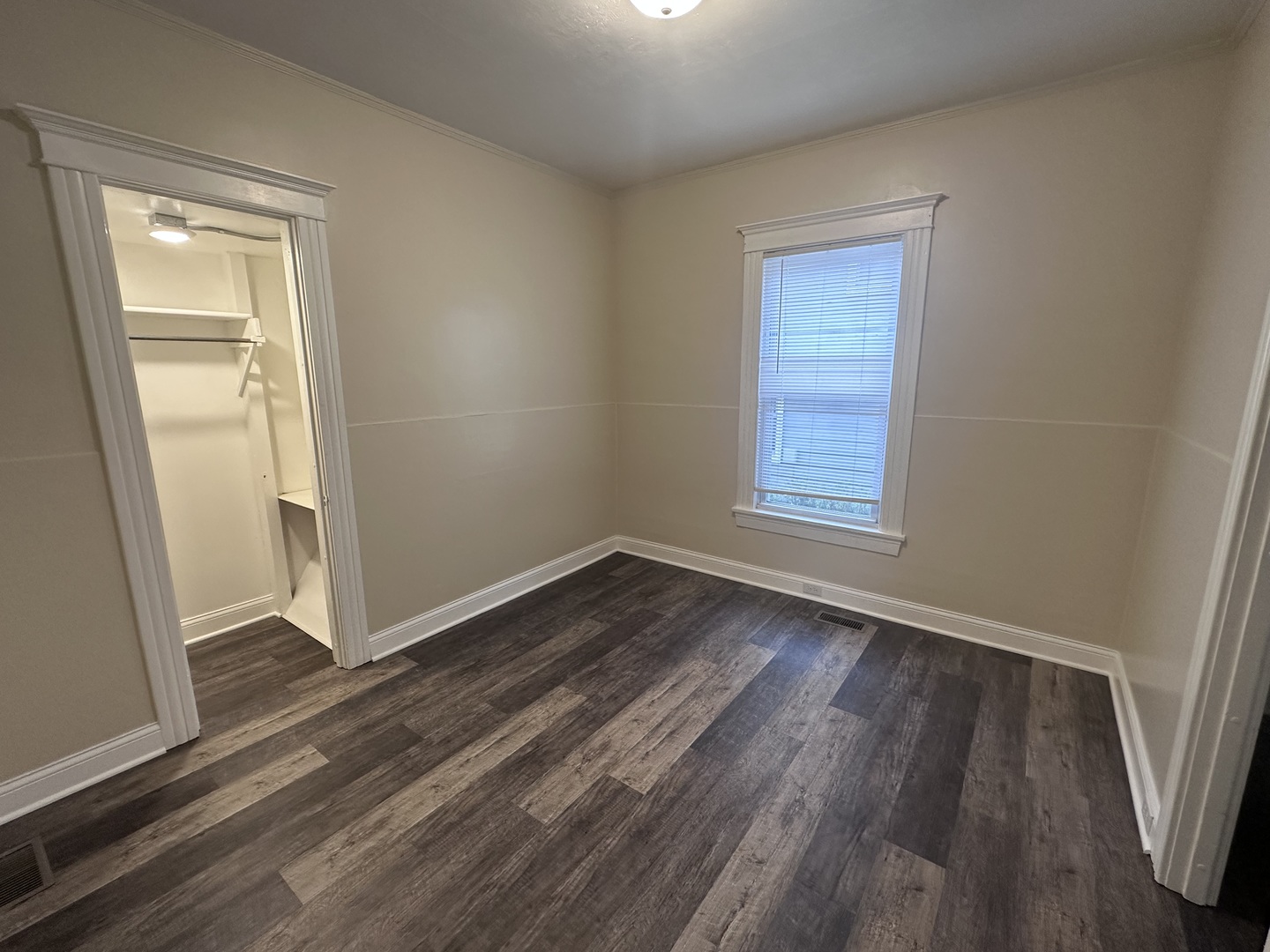 337 South Fordham Avenue Aurora, IL 60506 - Photo 5 of 10 an empty room with wooden floor and windows