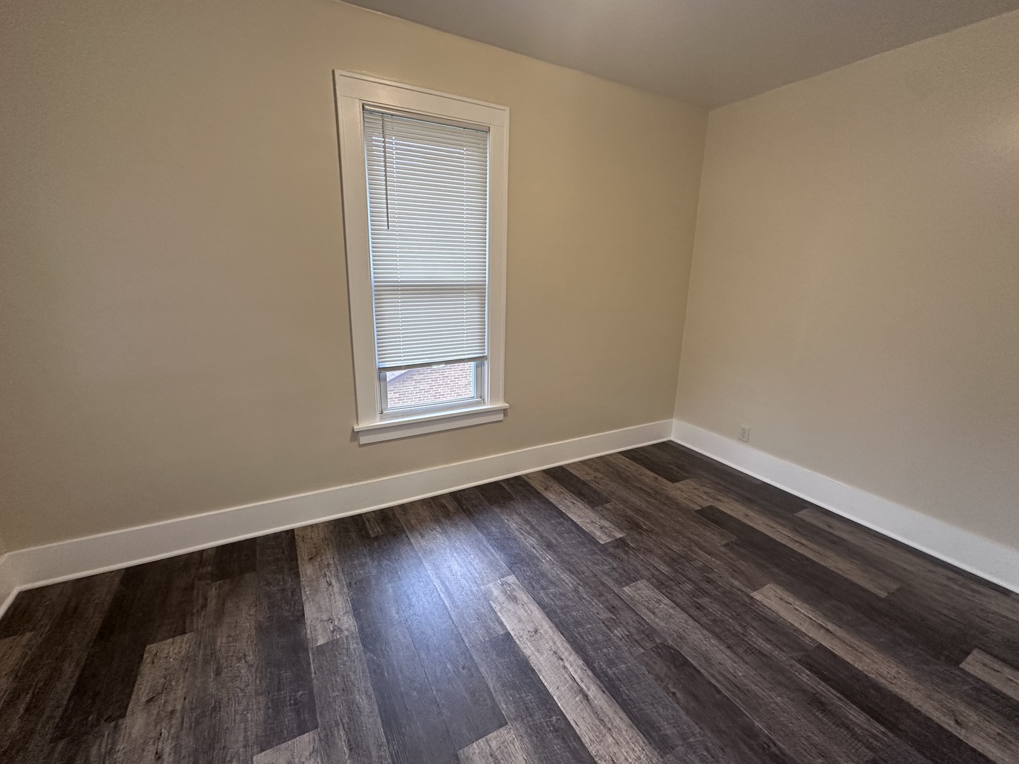 337 South Fordham Avenue Aurora, IL 60506 - Photo 6 of 10 an empty room with wooden floor and windows