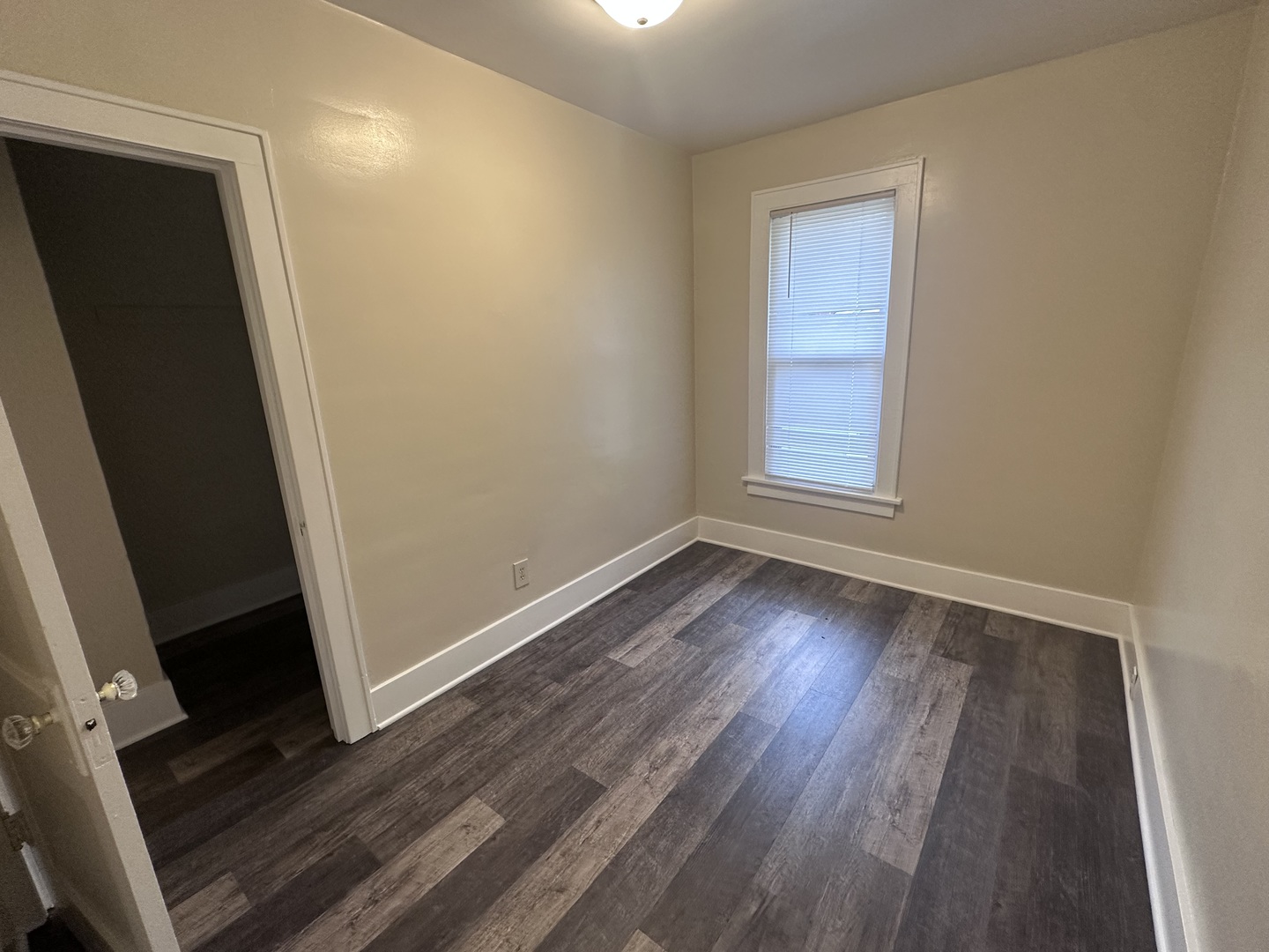337 South Fordham Avenue Aurora, IL 60506 - Photo 7 of 10 an empty room with wooden floor and window