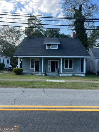 a view of a house with a yard and a large pool