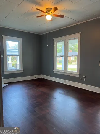 a view of a livingroom with wooden floor and a window