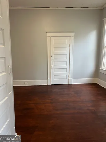 a view of an empty room and wooden floor