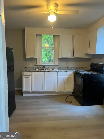a kitchen with a sink and cabinets