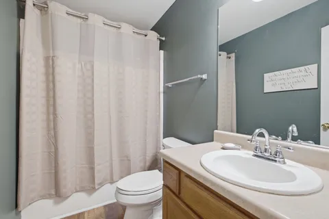 a bathroom with a sink toilet and a mirror