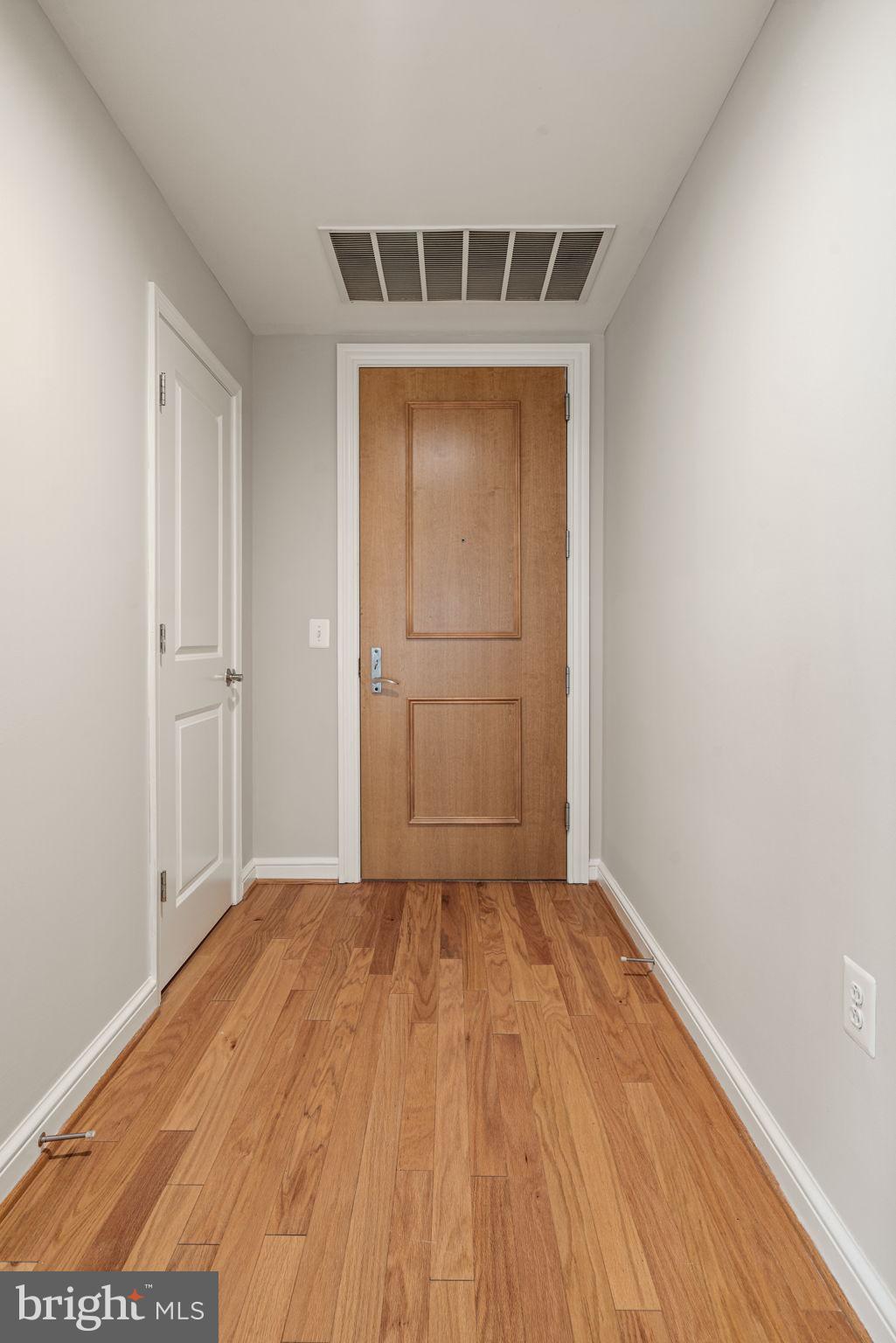 11990 Market Street, Unit 1311 Reston, VA 20190 - Photo 11 of 59 a view of empty room with wooden floor and windows